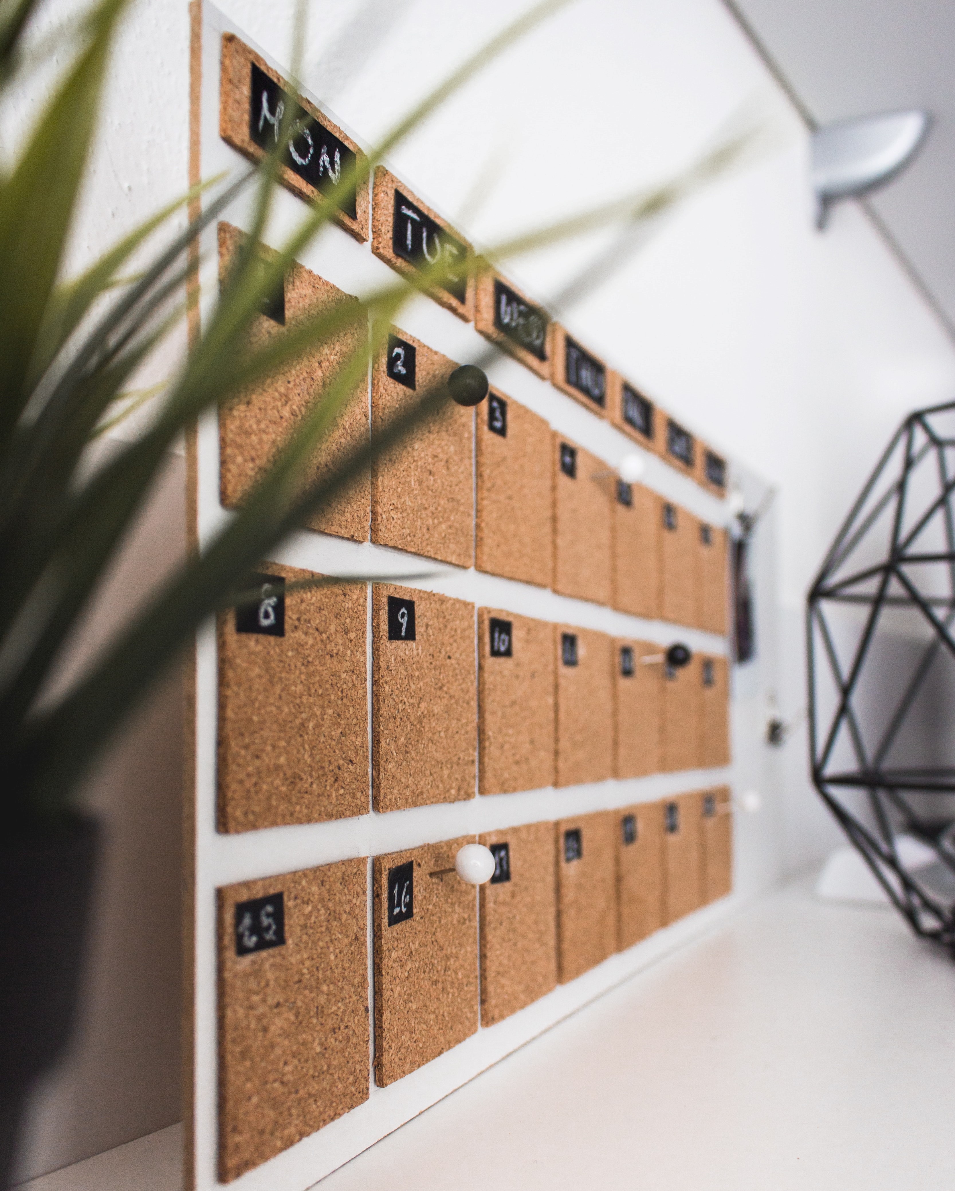 A corkboard calendar angled away from the viewer.